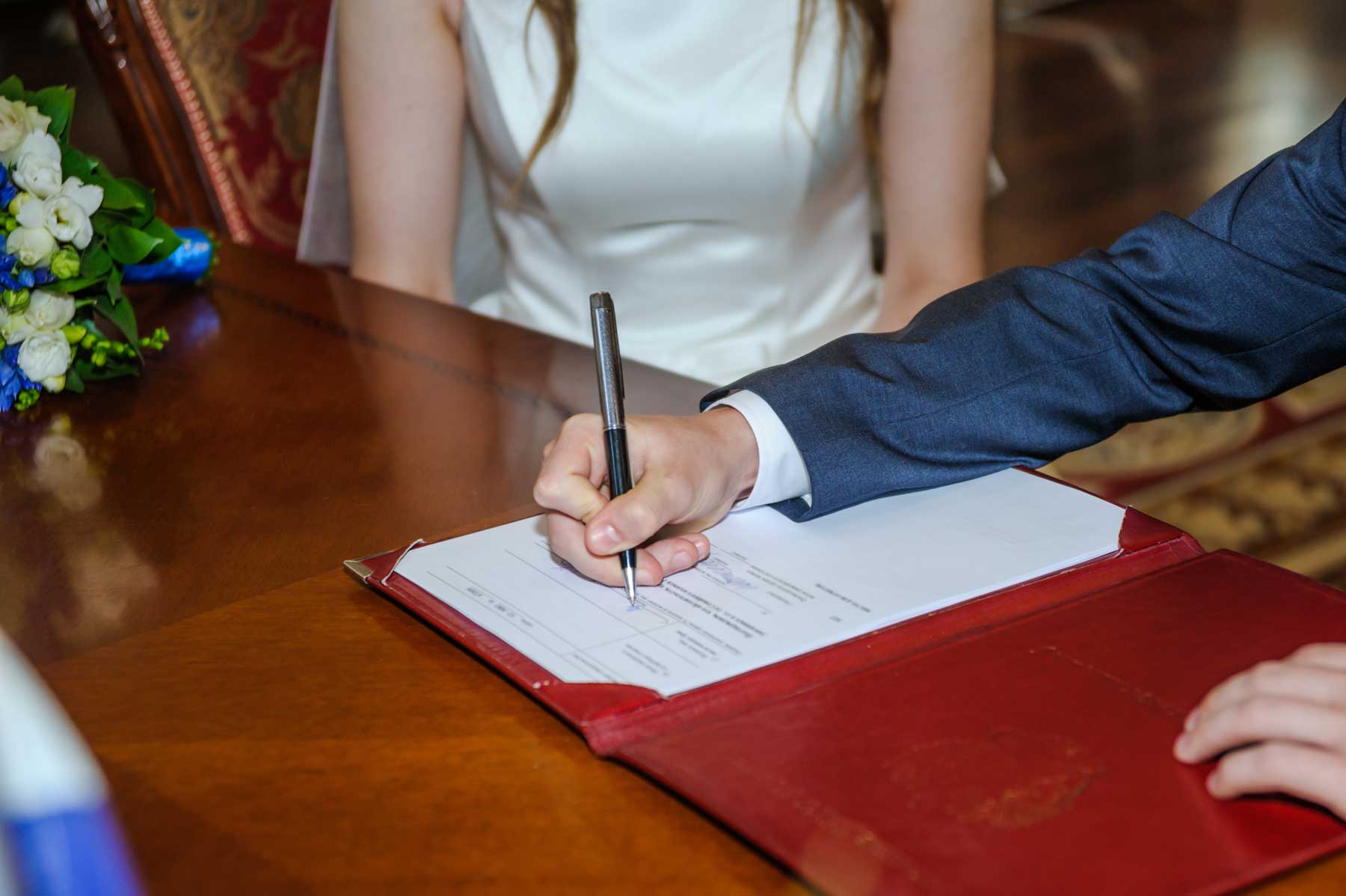 Newlyweds signing Public Marriage License